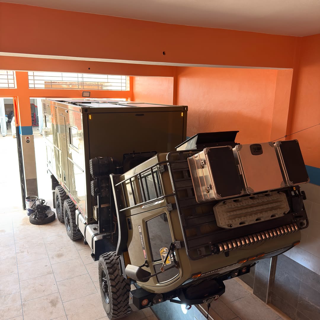 Acela 6x6 with cab tilted forward inside Garage Iriki workshop for engine service