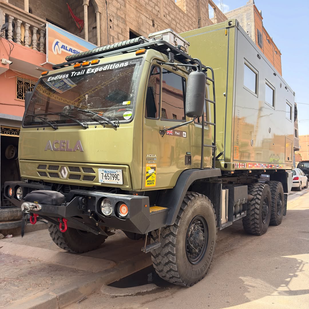 Side profile of the Acela 6x6 overland truck with Bliss Mobil habitat and roof rack in Zagora, Morocco
